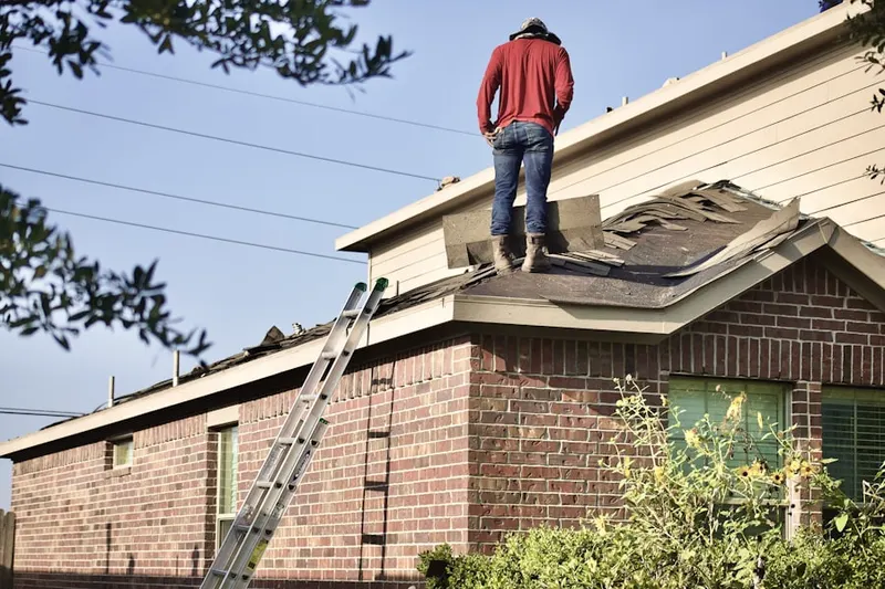 Professional roofer working on a residential roof in Valley Park